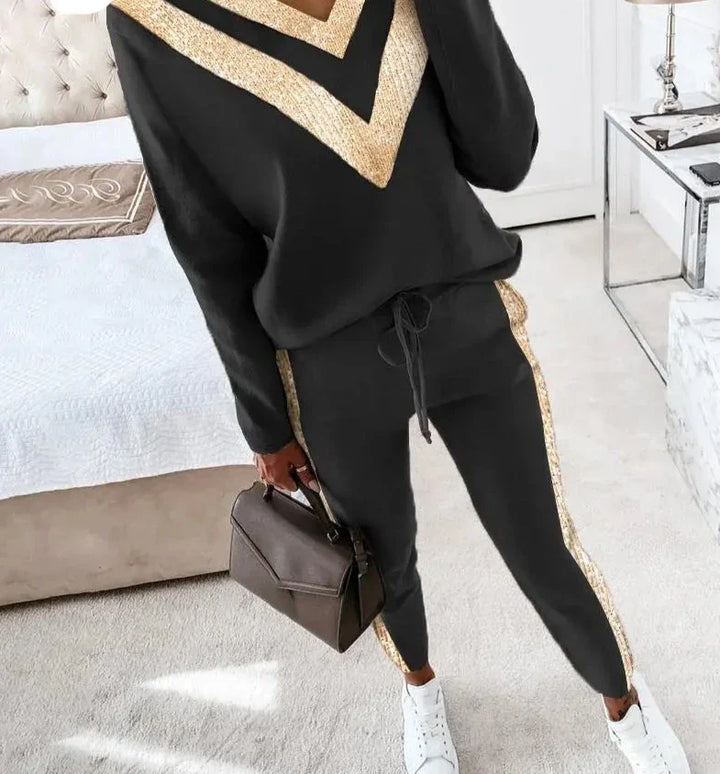 Chic black tracksuit with elegant gold accents for women