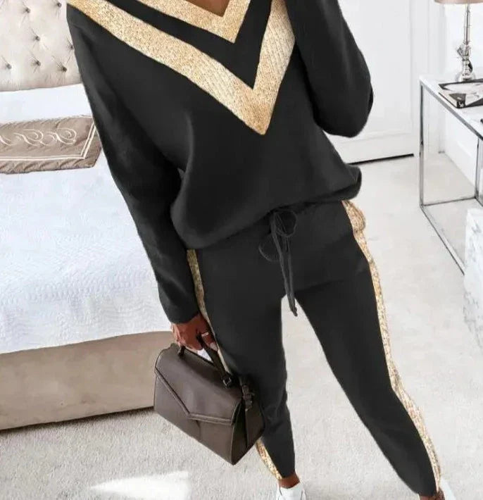 Chic black tracksuit with elegant gold accents for women