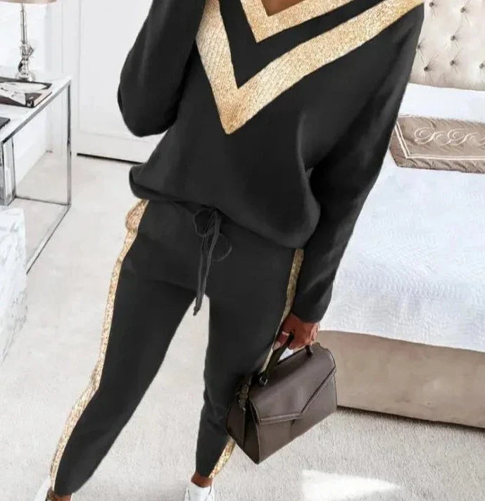 Chic black tracksuit with elegant gold accents for women