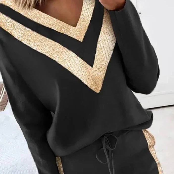 Chic black tracksuit with elegant gold accents for women